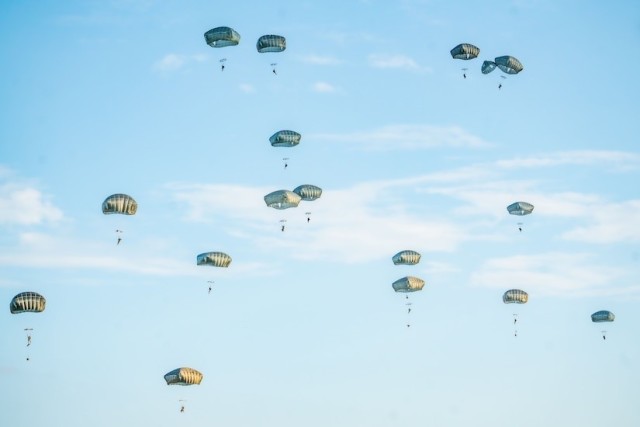 Army paratroopers assigned to the 82nd Airborne Division conduct a parachute jump at the Sicily Drop Zone, Aug. 21, 2024.