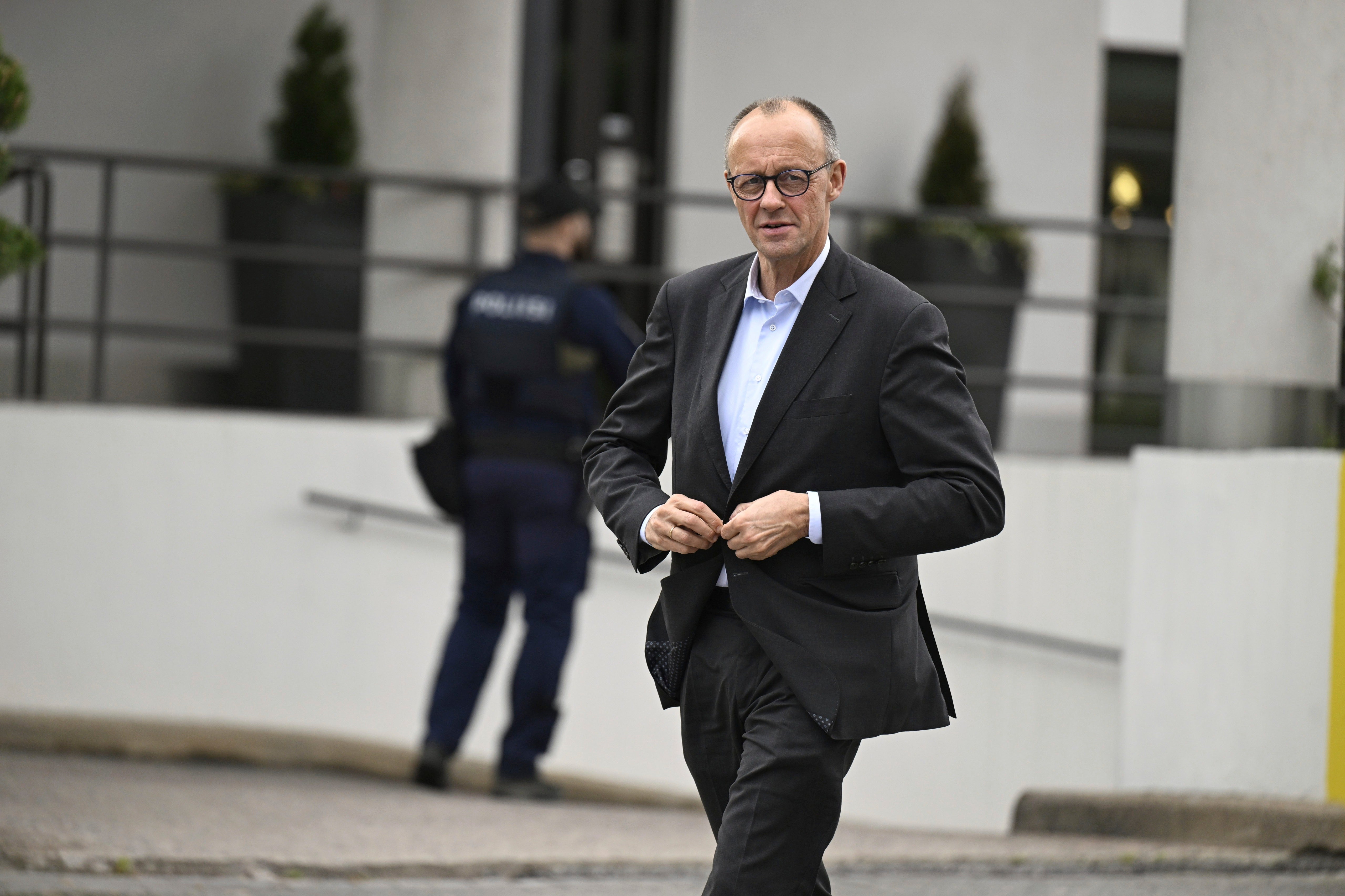Germany's chancellor Friedrich Merz walks before his meeting with Finland's prime minister Petteri Orpo in Turku