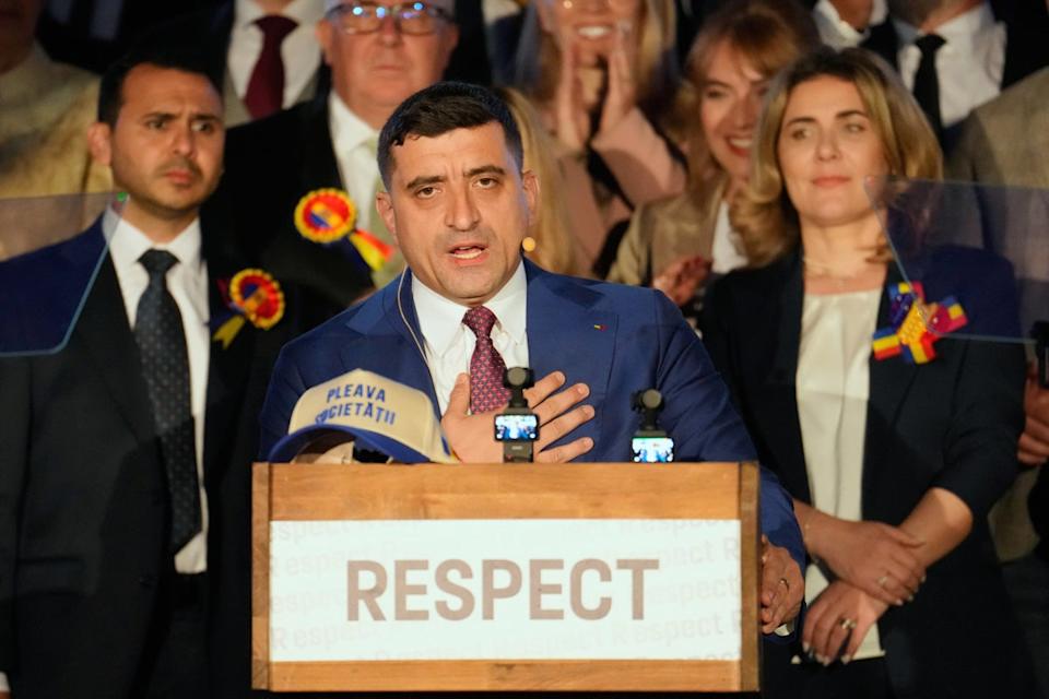 Presidential candidate George Simion speaks to media after polls close for second round of the country's presidential election redo in Bucharest on 18 May 2025 (AP)