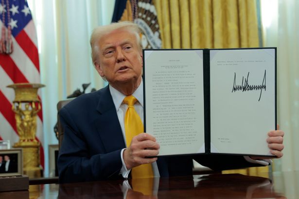 WASHINGTON, DC - MARCH 07: U.S. President Donald Trump holds up an executive order alongside President of Fédération Internationale de Football Association (FIFA) Gianni Infantino in the Oval Office at the White House on March 07, 2025 in Washington, DC. President Trump signed an executive order establishing a White House Task Force for the 2026 World Cup. (Photo by Anna Moneymaker/Getty Images)