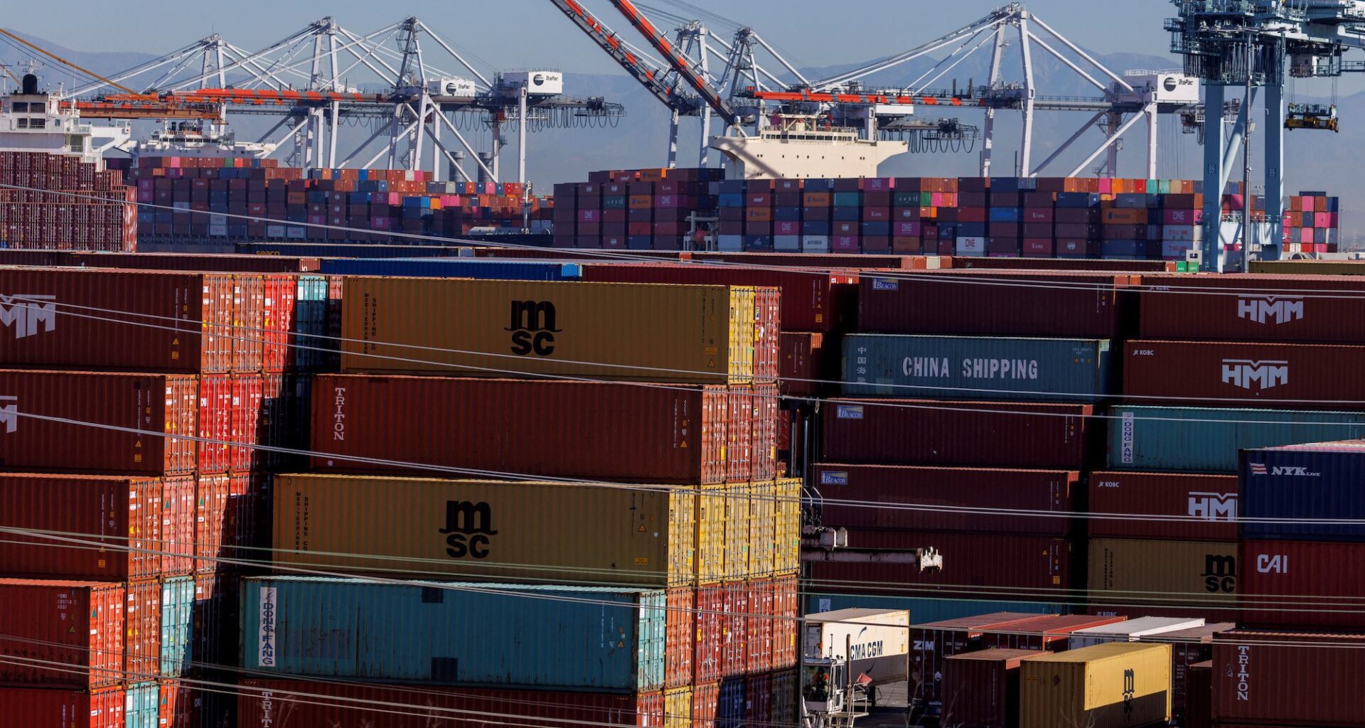 Stacked containers are shown as ships unload their cargo at the Port of Los Angeles in Los Angeles, California, U.S. November 22, 2021. REUTERS/Mike Blake/File Photo