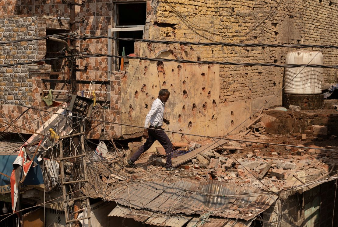 A man walks past a house damaged by Pakistan's strikes on Jammu, a city in India-administered Kashmir, on Saturday.