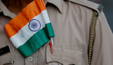 An Indian flag is pictured in the pocket of a police officer's uniform as he attends a rally in support of the Indian arme...