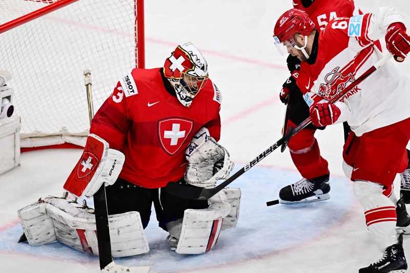 Ice hockey-Swiss end Denmark fairytale 7-0 to reach world championship final