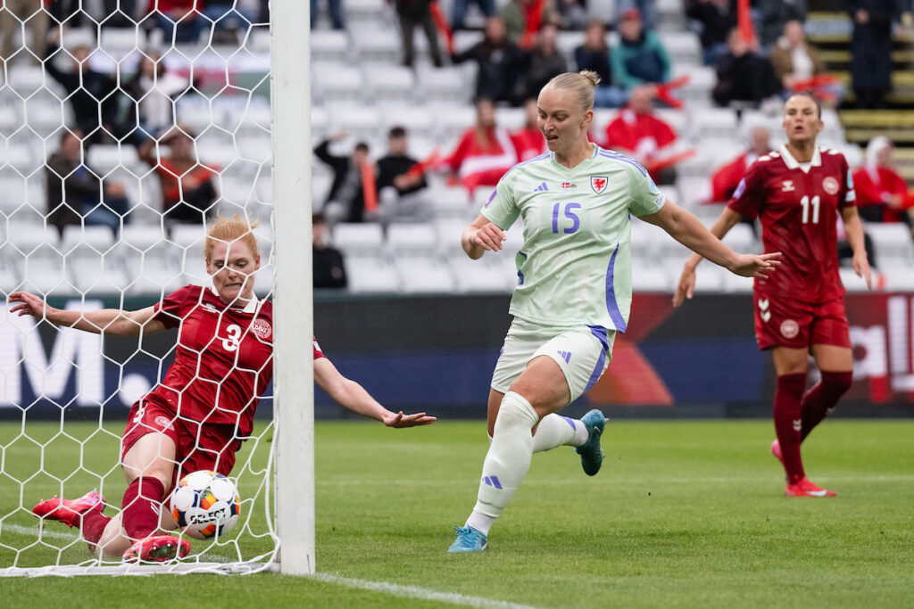 The ball crosses the line after a Jess Fishlock strike but the goal is not given as Elise Hughes looks on at a Denmark defender desperately trying to clear the ball. 