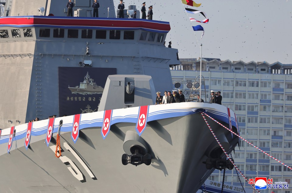 Kim Jong Un and his daughter attending the launching ceremony of a new North Korean destroyer.