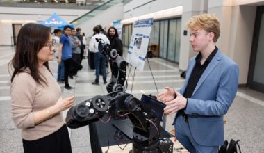 Dean Tina Choe learns about the capstone project of a student at the annual Engineering and Computer Science Design Showcase.