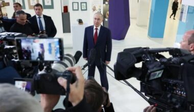 In this pool photograph distributed by the Russian state agency Sputnik, Russian President Vladimir Putin (center) speaks to journalists at the Sirius Educational Center in Sochi on May 19, 2025, after a telephone conversation with U.S. President Donald Trump.