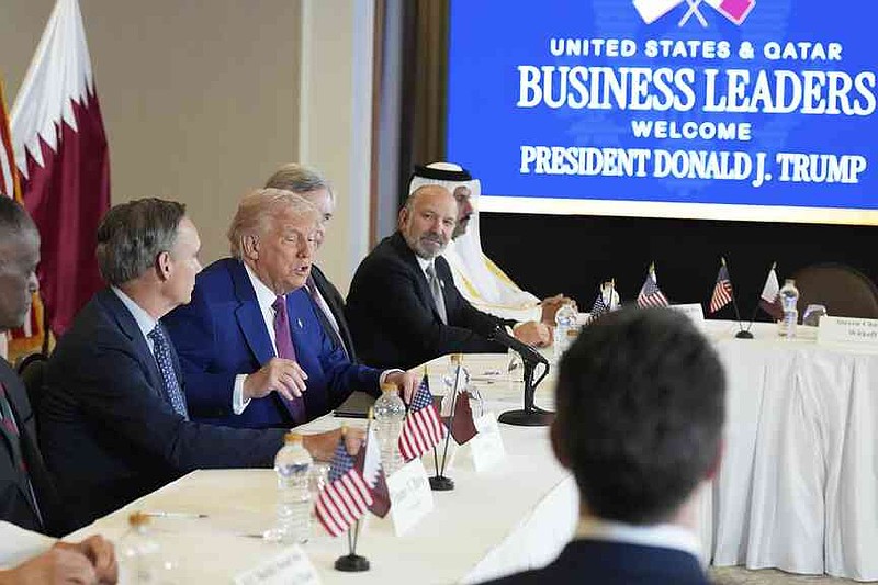 President Donald Trump speaks, seated between Kelly Ortberg President and CEO of Boeing, left, and Larry Culp, CEO of GE Aerospace during a business roundtable, Thursday, May 15, 2025, in Doha, Qatar. (AP Photo/Alex Brandon)