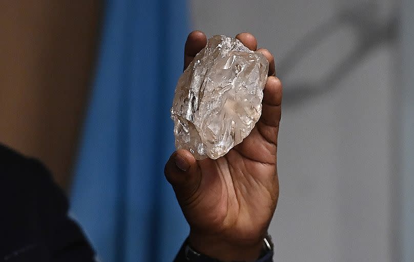 FILE - A person holds a 2,492-carat diamond which was found in the country and on show, in Gaborone, Botswana, Thursday, Aug. 22, 2024. (AP Photo, File)