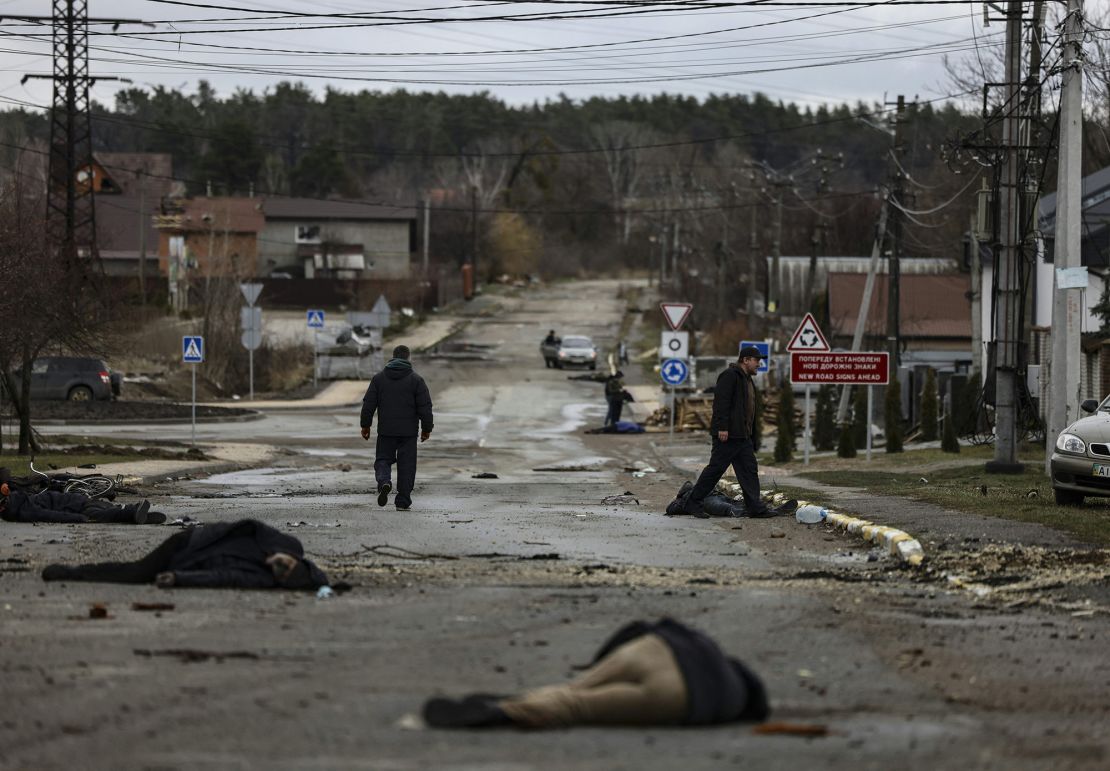 EDITORS NOTE: Graphic content / TOPSHOT - In this photo taken on April 2, 2022, bodies of civilians lie on Yablunska street in Bucha, northwest of Kyiv, after the Russian army pulled back from the city. The first body on the picture has been identified as Mykhailo Kovalenko, who was shot dead by Russian soldiers according to relatives interviewed by AFP. When the 62-year-old arrived on Yablunska, he
