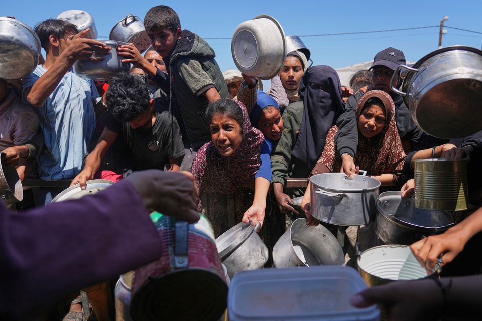 Palestinians receive food at a community kitchen in Khan Younis in the Gaza Strip. Photo: AP