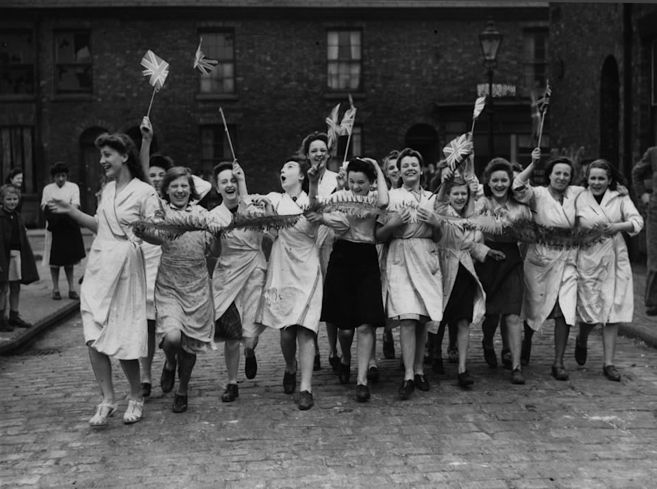 Workers celebrate Victory in Europe Day in Manchester at the end of the Second World War. 8th May 1945.
