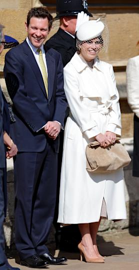 Princess Eugenie wearing a white coat and hat standing next to Jack Brooksbank on Easter 2025