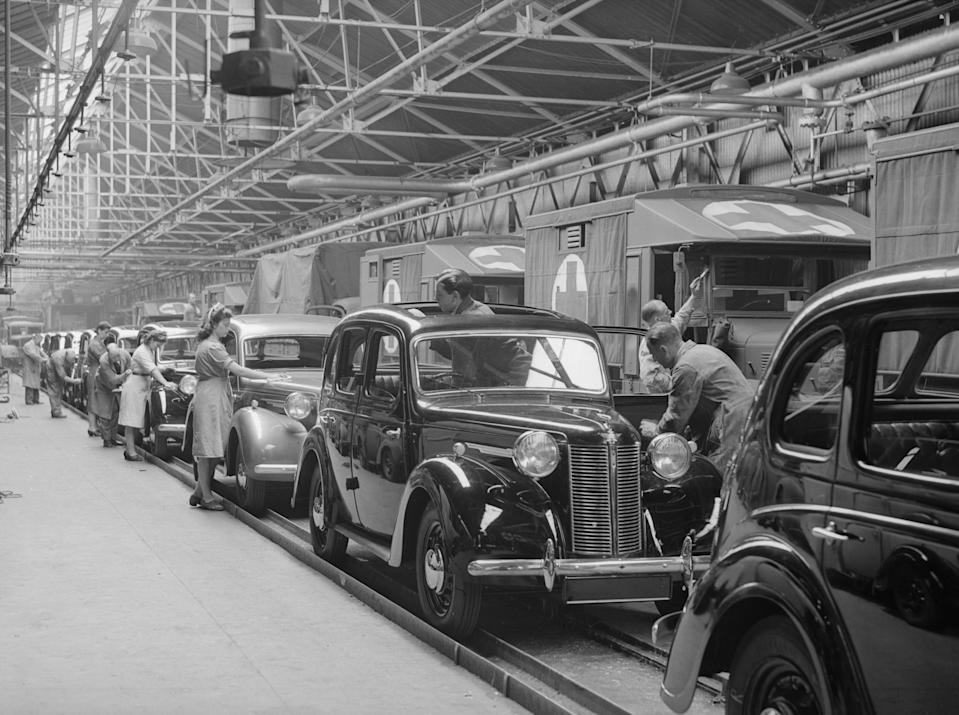 11th August 1945: A row of army ambulances still being manufactured at the Austin factory in Birmingham. But beside them are a line of new post-war 10 horsepower Austin cars for civilian use. (Photo by Keystone/Getty Images)