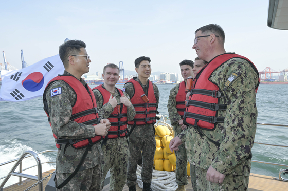 This file photo, provided by the South Korean Navy, shows Rear Adm. Neil Koprowski, right, commander of the U.S. Naval Forces Korea. [YONHAP]