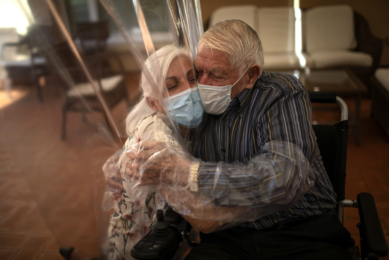 Dolores Reyes Fernández, 61, hugs her father, José Reyes Lozano, 87, for the first time in nearly four months as visits resume at the nursing home in Barcelona, Spain, Monday, June 22, 2020.