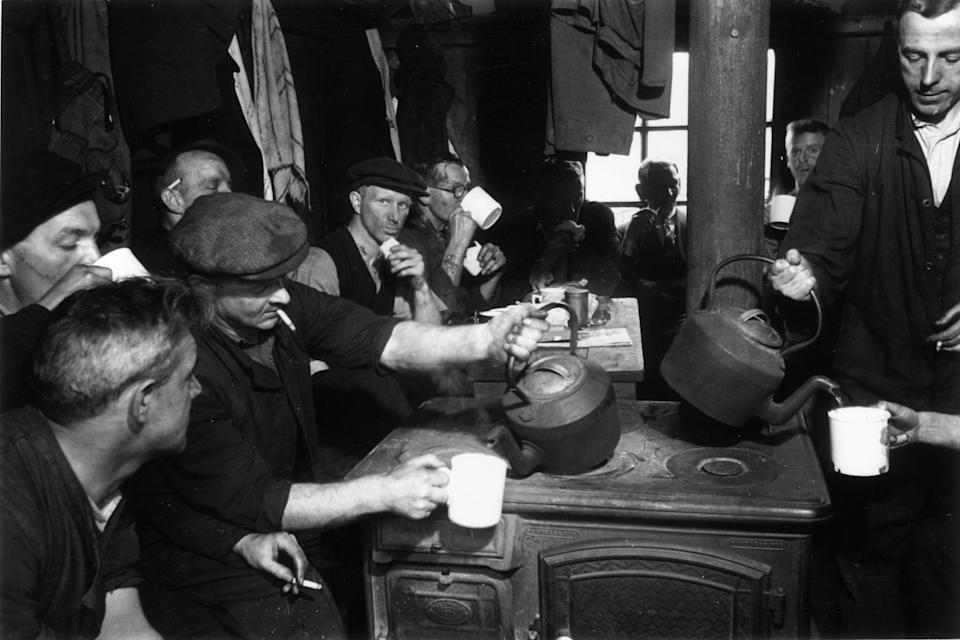 20th October 1945: The 'tunnel rats', a gang of maintenance men who keep Britain's railways in working order, enjoying a tea break. Original Publication: Picture Post - 3004 - The Tunnel Rats - pub. 1945 (Photo by Francis Reiss/Picture Post/Hulton Archive/Getty Images)