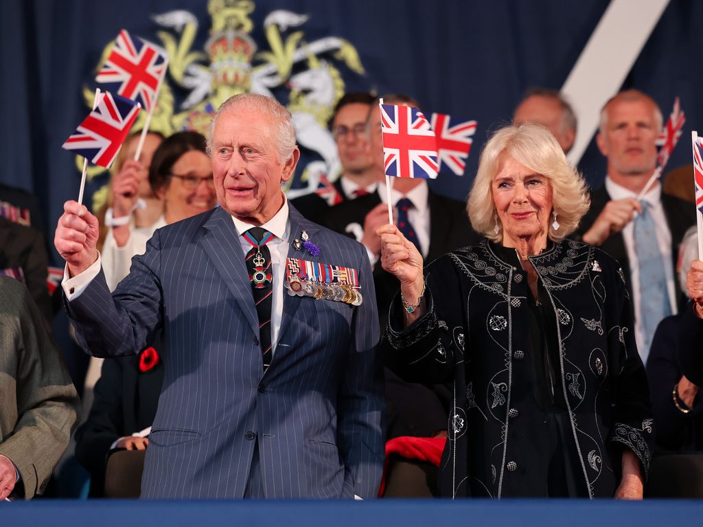 King Charles and Queen Camilla waving union flags
