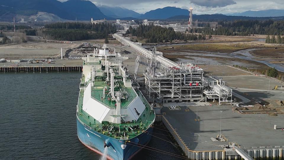 An LNG tanker in Kitimat, B.C. in April 2025. A flare can be seen in the background as the Canada LNG project prepares to come online.