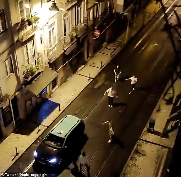 From another view, the group of tourists is seen running off as Daniel bleeds out in the street