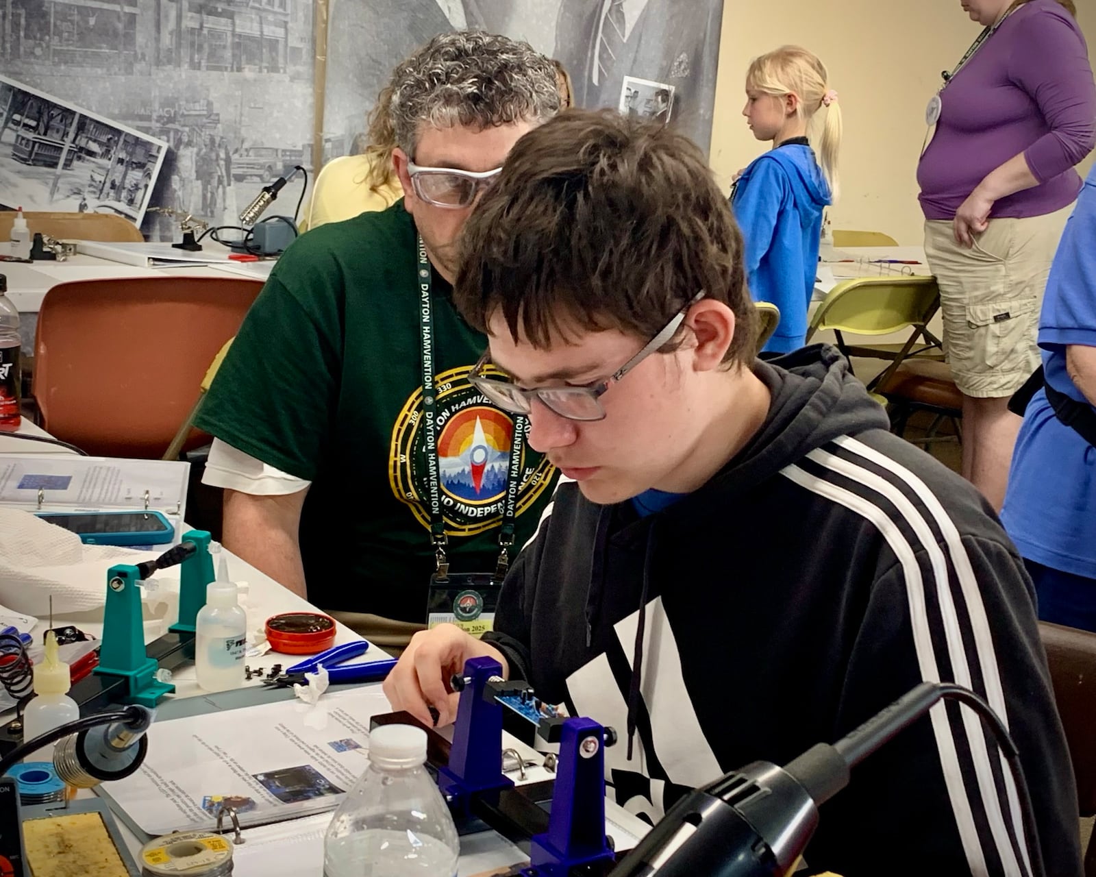 A young man works on soldering part of an FM radio at the Dayton Hamvention, Saturday May 17, 2025. The Dayton Hamvention returned to Xenia, May 16-18, 2025, bringing tens of thousands of people worldwide for a weekend of technology, radio, and entertainment. LONDON BISHOP/STAFF