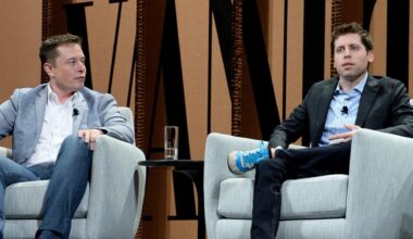 Elon Musk and Sam Altman sit in chairs on stage