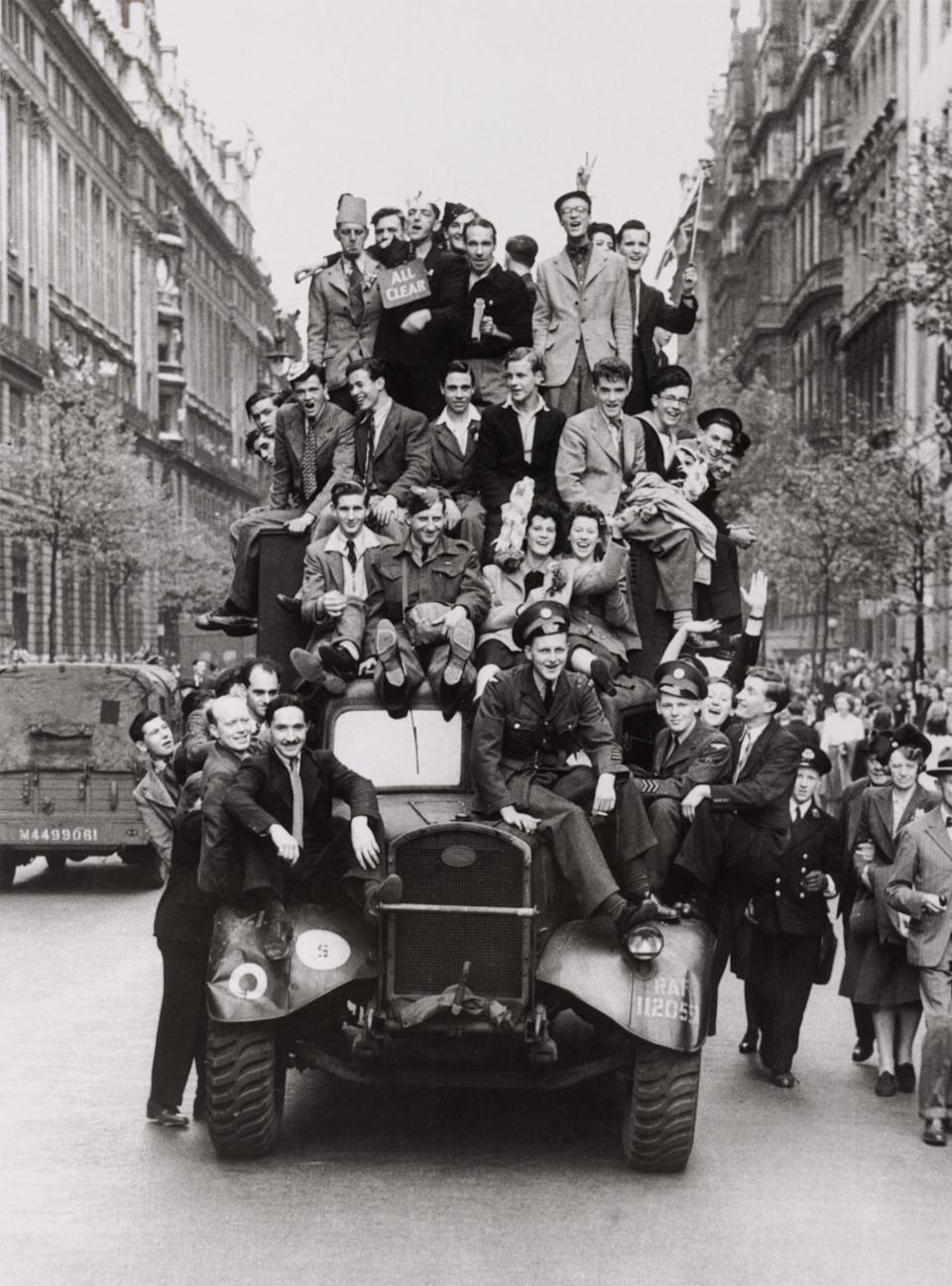 Crowd swarming all over a lorry on VE day. World War Two: VE Day. Crowd swarming all over a lorry on VE Day, central London, 8 May 1945. (Photo by Daily Herald Archive/National Science & Media Museum/SSPL via Getty Images)