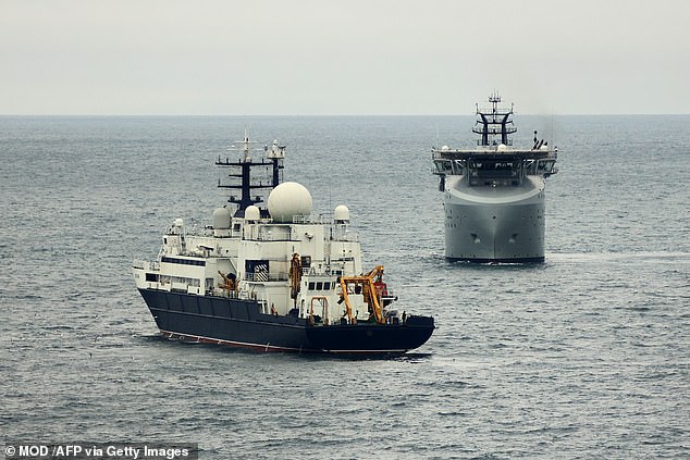 A handout picture released by the Britain's Ministry of Defence (MOD) in London on January 22, 2025 shows Royal Navy Royal Navy of RFA Proteus (R) patrolling near the Russian vessel Yantar (L), in November 2024