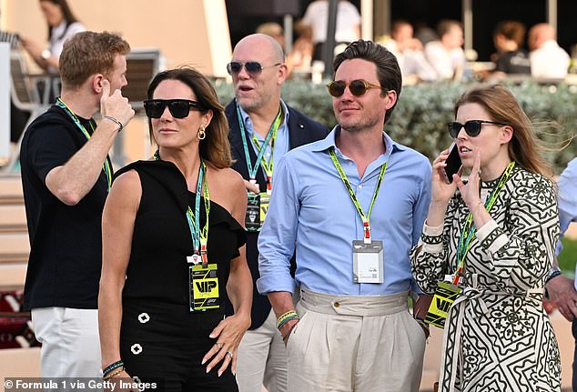 The group was spotted in the paddock during the race at the Bahrain International Circuit chatting and laughing in the sunshine with Mike Tindall chatting animatedly behind