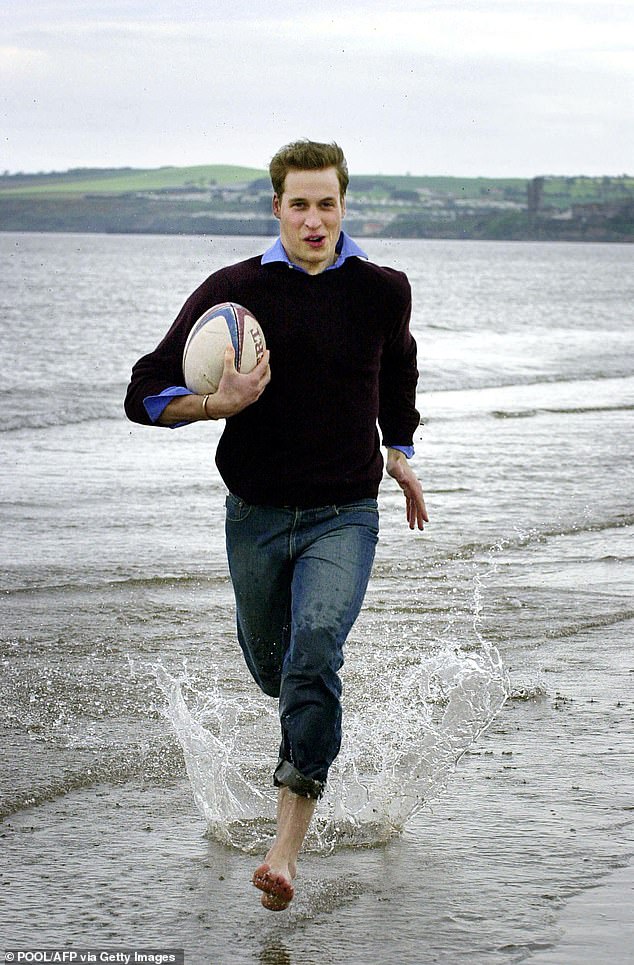 William runs with a rugby ball on the beach in St Andrews