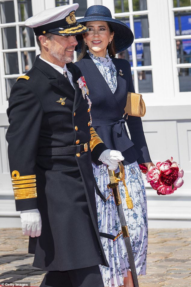 Underneath a smart navy wrap blazer, Queen Mary wore a flowing, floral midi dress, featuring a high neck