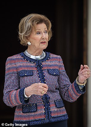 The statement top was stylishly decorated with golden studs around the collar and pockets