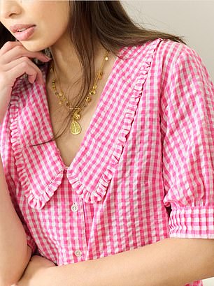 Delicate frill accents, short puff sleeves and split side seams add to its feminine appeal, all in a peony pink hue that's ideal for warmer days
