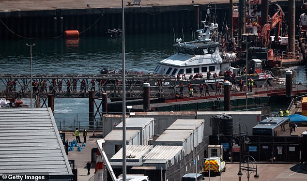 Illegal migrants disembark from a Border Force vessel into Dover port on May 12, 2025 in Dover