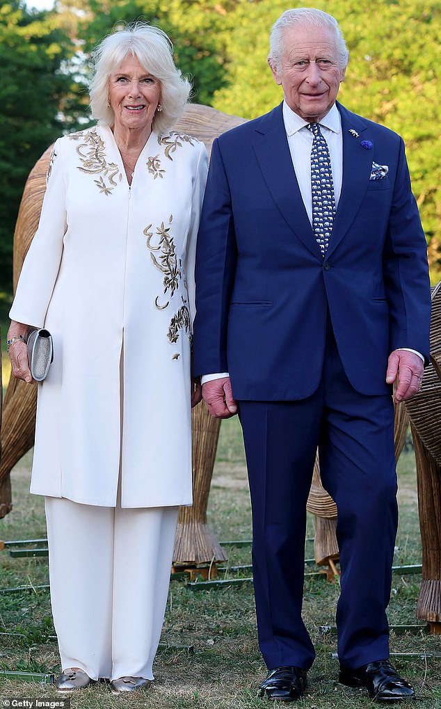 The 77-year-old Queen wore a cream tunic top with gold embroidery and matching cream palazzo trousers by designer Anna Valentine