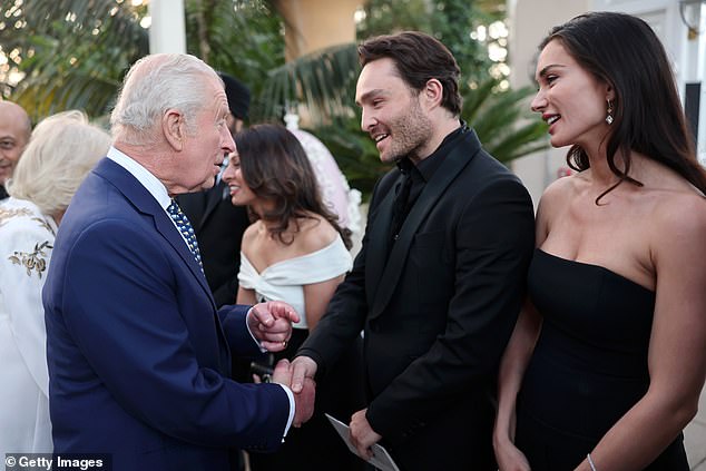 Ed Westwick and Amy Jackson are pictured smiling as they meet King Charles and Queen Camilla