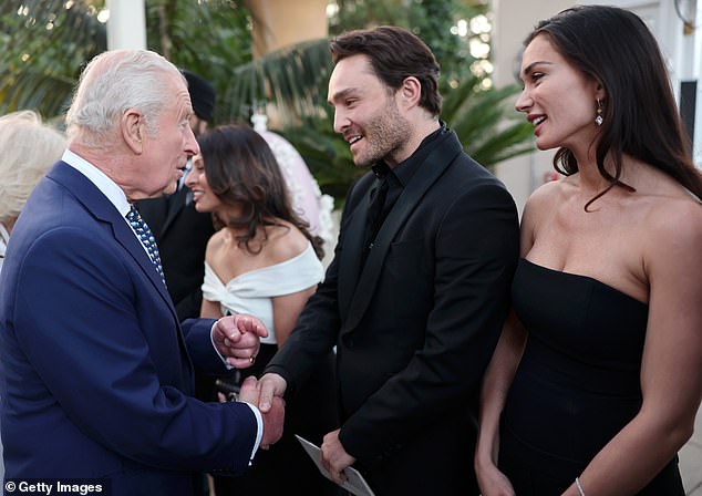 Westwick and Jackson are pictured smiling as they meet King Charles and Queen Camilla