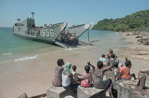 According to Robert Hardman: 'Monarchs do not speak out, even when the US really does invade one of their realms – as when Ronald Reagan invaded Grenada in 1983 without even forewarning the Queen of Grenada.' Pictured: United States Marines pull out of Grenada as children wave at them