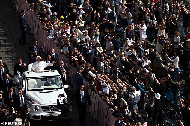 Pope Leo XIV arrives on the popemobile for his inaugural Mass at the Vatican