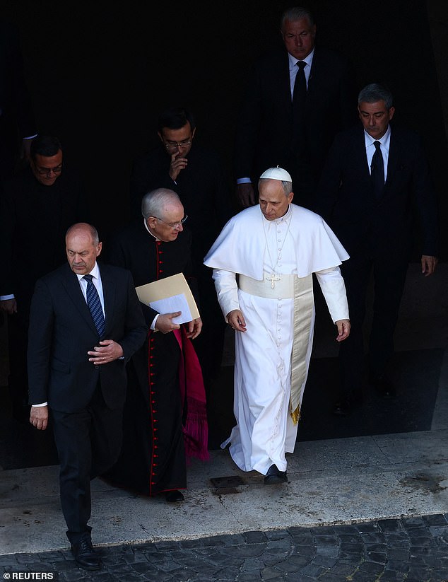 Pope Leo XIV walks towards the popemobile on the day of his inaugural Mass