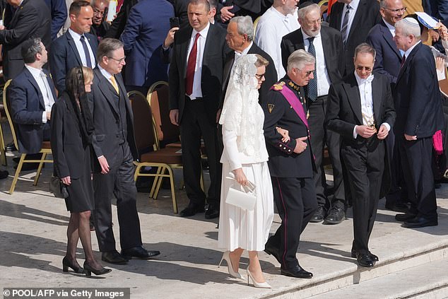 Belgium's King Philippe (second from the right) and Belgium's Queen Mathilde (centre) arrive to attend the Holy Mass