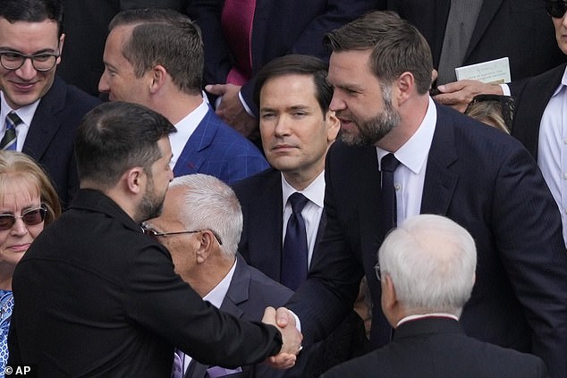 Ukraine's President Volodymr Zelensky and Vice President JD Vance greet each other as Secretary of State Marco Rubio (centre) looks on