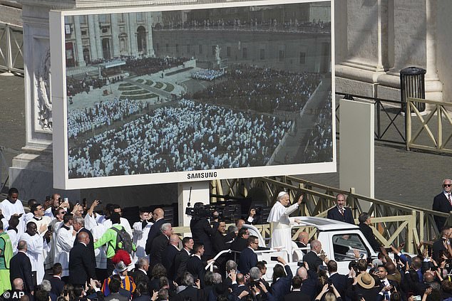Pope Leo XIV on his popemobile tours St Peter's Square at the Vatican which was being beamed onto giant Samsung television screens