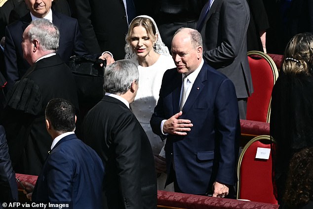 Prince Albert II of Monaco (right) and his wife Princess Charlene of Monaco arrive to attend a Holy Mass