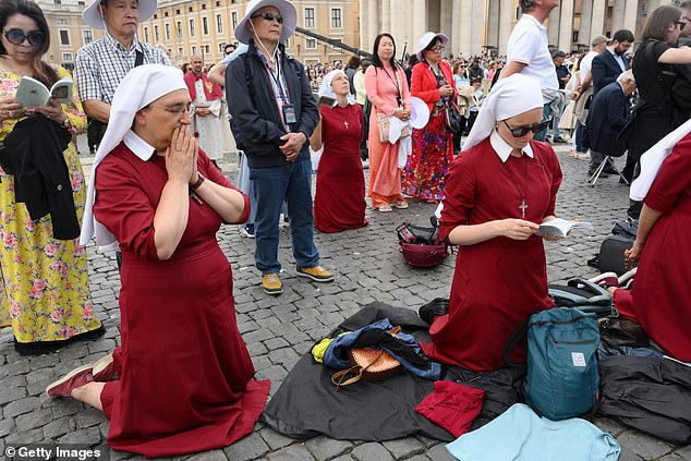 Nuns pray during the inauguration mass of Pope Leo XI