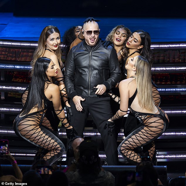 Mariah will perform alongside US rapper Wiz Khalifa and Pitbull (pictured)