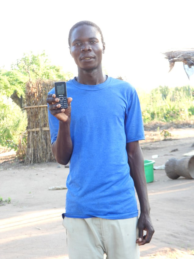 The two-year Chikwawa project is part of a ramping-up of UK overseas aid for climate resilience with ¿at least £1.5 billion¿ spent in 2024-25, according to the Foreign Office (Pictured: a beneficiary showing a free phone he received)