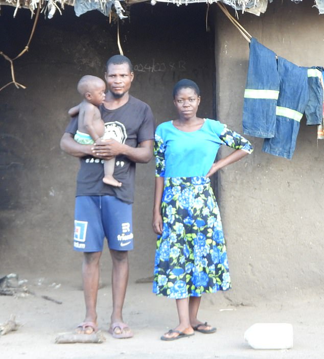 About 8,800 villagers around Chikwawa in Malawi are receiving the equivalent of £433 each ¿ and the Foreign Office insists the best way to send the money is directly to each of them (Pictured: Essau Harold outside his house with his new wife he married after receiving the funds)