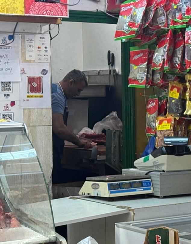 When MailOnline visited, a shop worker could be seen chopping raw meat with his bare hands